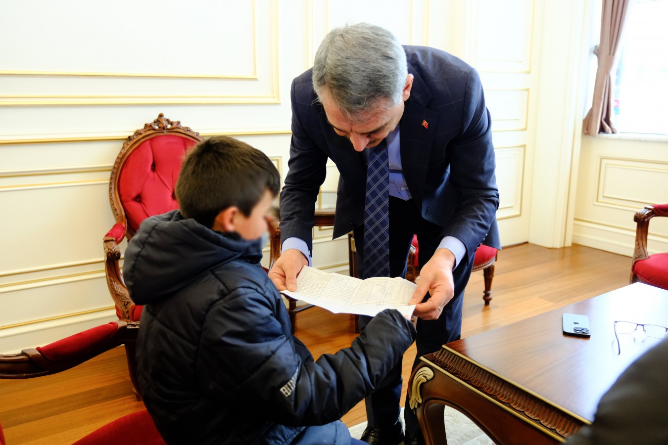 Halk gününe karnesiyle gelen çocuğa hediye verdi